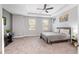 Bright bedroom with two windows and a simple bed, providing a serene and comfortable space for relaxation at 661 Hangnest Ln, Lake Mary, FL 32746