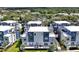 Aerial view of modern townhomes showcasing the community layout with lush landscaping and outdoor lounge spaces at 7770 Sandy Ridge Dr # 117, Reunion, FL 34747