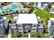 A modern condo building overlooks a luxurious pool area with lush landscaping and contemporary architecture at 7770 Sandy Ridge Dr # 117, Reunion, FL 34747