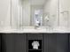 Modern bathroom with double sinks, sleek gray cabinets, and a large mirror at 7770 Sandy Ridge Dr # 117, Reunion, FL 34747