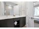 Bathroom featuring double sinks, modern fixtures, and view into the bedroom, blending style and functionality at 7770 Sandy Ridge Dr # 117, Reunion, FL 34747