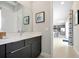 Modern bathroom featuring dark vanity with a light countertop, a mirror, and stylish fixtures at 7770 Sandy Ridge Dr # 117, Reunion, FL 34747