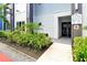 Building entrance showcasing modern design, manicured landscaping, and clear unit number signage at 7770 Sandy Ridge Dr # 117, Reunion, FL 34747