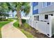 Inviting modern townhome features a private patio with access to a landscaped walkway and lush green spaces at 7770 Sandy Ridge Dr # 117, Reunion, FL 34747