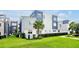 Modern two-story townhome showcasing a well-maintained lawn, privacy fence, and contemporary architectural details at 7770 Sandy Ridge Dr # 117, Reunion, FL 34747