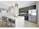 Stylish kitchen featuring a white island, stainless steel appliances, and modern cabinetry at 7770 Sandy Ridge Dr # 117, Reunion, FL 34747