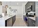Modern kitchen featuring stainless steel appliances, gray cabinetry, and a large island with pendant lighting at 7770 Sandy Ridge Dr # 117, Reunion, FL 34747