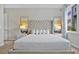 Well lit main bedroom with a tufted headboard and soft decor at 7770 Sandy Ridge Dr # 117, Reunion, FL 34747