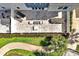 Aerial view of a private patio with contemporary outdoor furniture, complemented by lush greenery and a walkway at 7770 Sandy Ridge Dr # 117, Reunion, FL 34747
