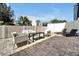 Private patio with sleek furniture, sun loungers, and a white fence, perfect for outdoor relaxation and entertainment at 7770 Sandy Ridge Dr # 117, Reunion, FL 34747