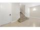 Interior view of a modern condo's stairway with a neutral color palette and tile flooring at 7770 Sandy Ridge Dr # 117, Reunion, FL 34747