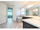 Bright bathroom featuring a soaking tub, double vanity, and tiled floors at 8066 Ludington Cir, Orlando, FL 32836