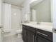 Bathroom with a shower and tub combination and a sleek vanity with modern fixtures at 8066 Ludington Cir, Orlando, FL 32836