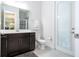 Bathroom featuring a modern vanity with dark wood cabinetry and a walk-in shower at 8066 Ludington Cir, Orlando, FL 32836