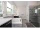 Bright bathroom featuring a tub, shower, vanity and grey tiled flooring at 8066 Ludington Cir, Orlando, FL 32836