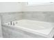 Close up of bathtub with tile surround and modern fixtures at 8066 Ludington Cir, Orlando, FL 32836