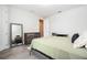 Bright bedroom with a large mirror, wood-look flooring, dresser, and desk at 8066 Ludington Cir, Orlando, FL 32836