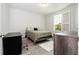 Bedroom with a bed, desk and shuttered window for natural light, providing a comfortable and functional space at 8066 Ludington Cir, Orlando, FL 32836