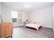 Well-lit bedroom with a window, desk, wood-look flooring and a modern minimalist design at 8066 Ludington Cir, Orlando, FL 32836