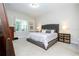 Bright bedroom with gray upholstered headboard, carpet flooring and window at 8066 Ludington Cir, Orlando, FL 32836