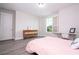 Comfortable bedroom featuring modern flooring, a desk by the window, and stylish dresser at 8066 Ludington Cir, Orlando, FL 32836