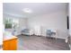 Bright bedroom with modern floors, a full sized bed, a desk, and a dresser at 8066 Ludington Cir, Orlando, FL 32836