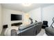 Bonus room with large tv, comfortable seating, and exercise equipment at 8066 Ludington Cir, Orlando, FL 32836