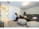 A versatile bonus room features gray flooring, exercise equipment, and a comfortable leather sofa with bean bag chairs at 8066 Ludington Cir, Orlando, FL 32836