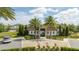 View of the clubhouse with pool access and palm trees in a gated community at 8066 Ludington Cir, Orlando, FL 32836