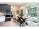 Dining area with a modern table, stylish chairs, and a sliding door view of the pool at 8066 Ludington Cir, Orlando, FL 32836