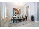 Bright dining room featuring a modern table, contemporary chandelier and decorative china cabinet at 8066 Ludington Cir, Orlando, FL 32836