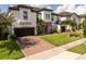 Beautiful two-story home showcasing a well-kept lawn, brick-paved driveway, and an attached two-car garage at 8066 Ludington Cir, Orlando, FL 32836