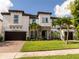 Attractive two-story home with a well-manicured lawn, brick-paved driveway, and an attached two-car garage at 8066 Ludington Cir, Orlando, FL 32836