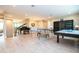 Spacious game room featuring ping pong table, bar area, and bookcase at 8066 Ludington Cir, Orlando, FL 32836