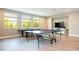 Spacious game room featuring ping pong and pool tables, large windows, and a tv at 8066 Ludington Cir, Orlando, FL 32836