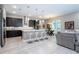Open-concept kitchen with island, pendant lighting, stainless appliances, and adjacent living area at 8066 Ludington Cir, Orlando, FL 32836