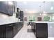 Modern kitchen featuring stainless steel appliances, white countertops, and stylish dark wood cabinetry at 8066 Ludington Cir, Orlando, FL 32836