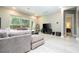 Cozy living room featuring a large TV, comfortable seating, and bright natural light at 8066 Ludington Cir, Orlando, FL 32836