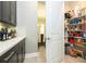 Walk-in pantry boasts shelving, providing ample storage space next to the kitchen and dining room at 8066 Ludington Cir, Orlando, FL 32836
