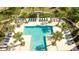 Aerial view of a luxurious community pool with lounge chairs and landscaping at 8066 Ludington Cir, Orlando, FL 32836