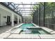 The screened in pool area includes a spa and outdoor seating, perfect for relaxing at 8066 Ludington Cir, Orlando, FL 32836