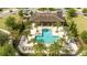 Aerial view of community pool and clubhouse surrounded by manicured landscaping at 8066 Ludington Cir, Orlando, FL 32836