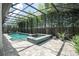 Beautiful screened pool and spa with ample patio space surrounded by tropical bamboo landscaping at 8066 Ludington Cir, Orlando, FL 32836