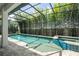 Relaxing screened-in pool and spa area surrounded by lush bamboo landscaping for ultimate privacy at 8066 Ludington Cir, Orlando, FL 32836