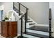 Modern staircase with dark wood steps and a metal railing, complemented by decorative accents at 8066 Ludington Cir, Orlando, FL 32836