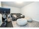Cozy entertainment room with oversized bean bags, comfortable seating, and a large flat screen TV at 8066 Ludington Cir, Orlando, FL 32836