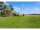 Sprawling backyard with lush green grass and a serene lake view, creating a peaceful oasis at 8806 Geneve Ct, Kissimmee, FL 34747