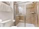 Bathroom featuring a glass shower with tiled walls, a white toilet, and a towel rack at 8806 Geneve Ct, Kissimmee, FL 34747