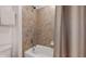 Bathroom with tile shower, bathtub, and neutral-colored shower curtain at 8806 Geneve Ct, Kissimmee, FL 34747