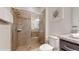 Bathroom featuring a glass enclosed shower, granite countertop and tile flooring at 8806 Geneve Ct, Kissimmee, FL 34747